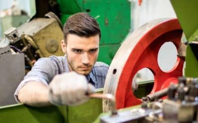 Technician repairing an industrial machine, illustrating servitization and service ERP requirements