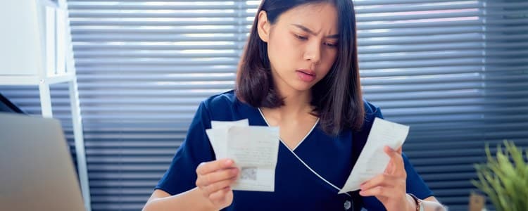 Employee reviewing payroll records with a concerned expression after an ERP data migration